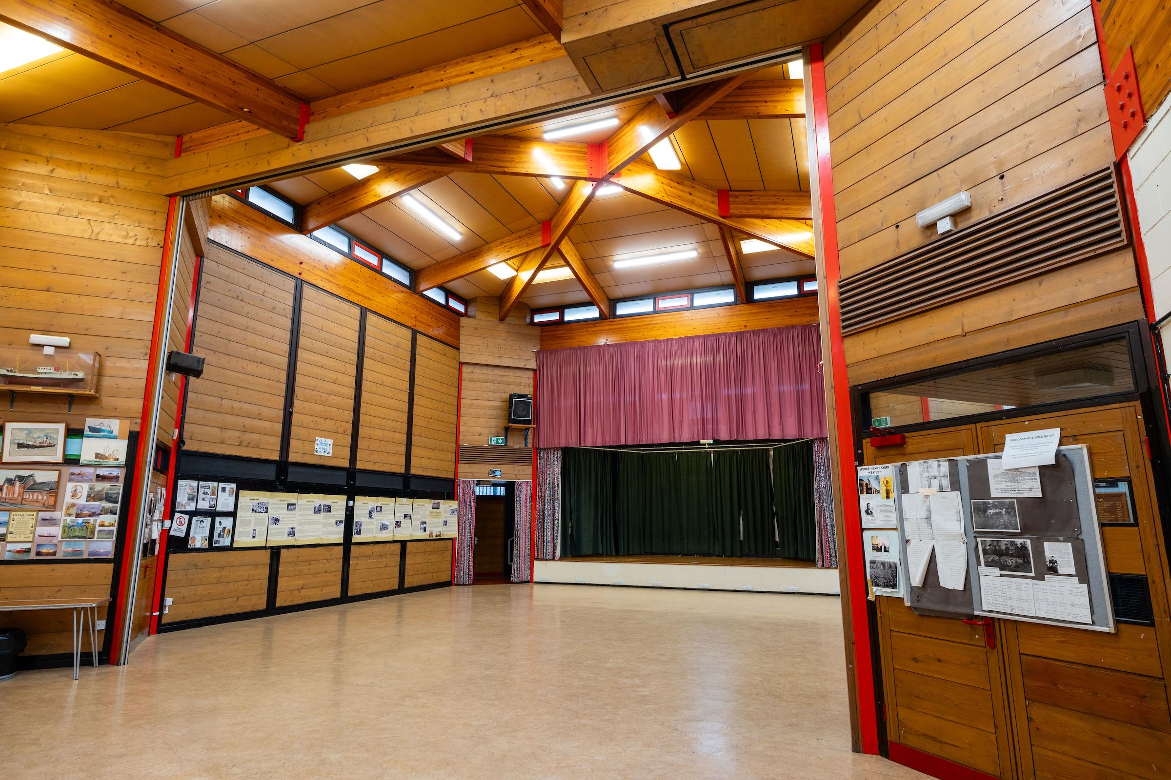 A photograph of the Edinburgh Street community centre main hall from the back of the room looking at the stage.