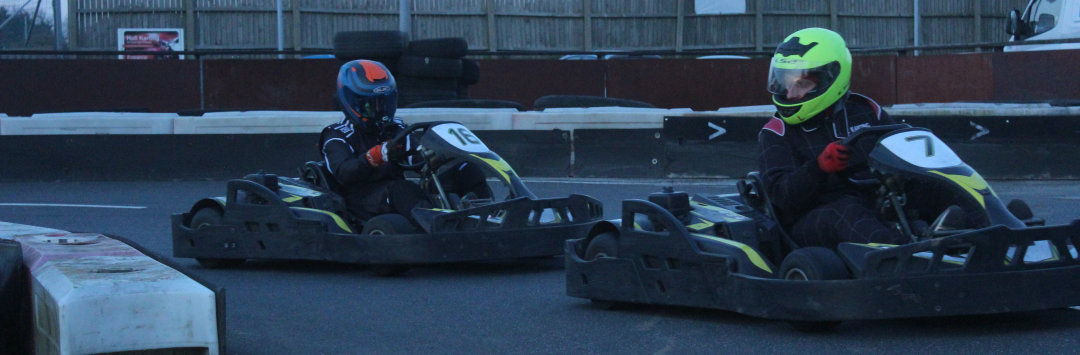 An image of a racer defending his position, looking over his shoulder at the kart behind