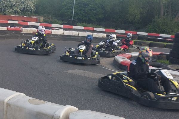 decorative image showing karts racing in a group