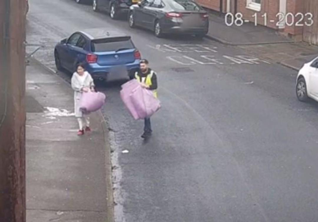 Two people walking in street