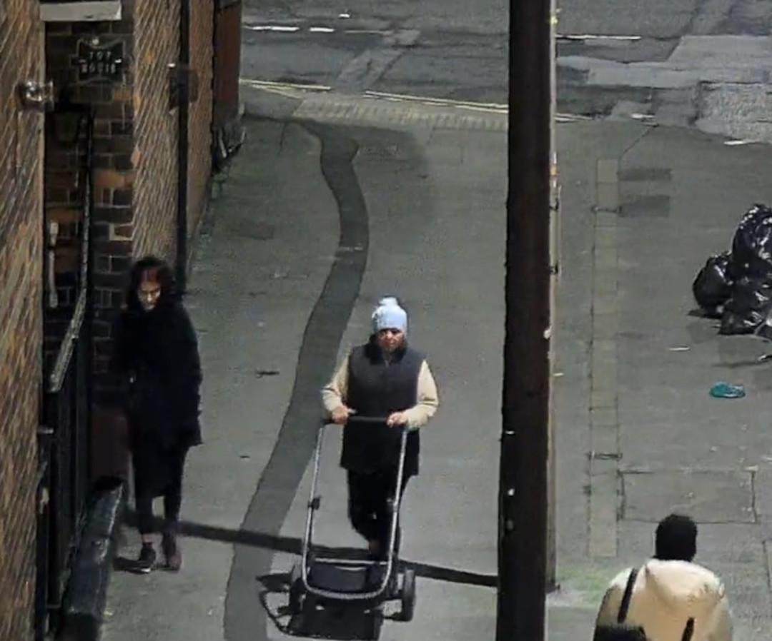 Two women standing in street