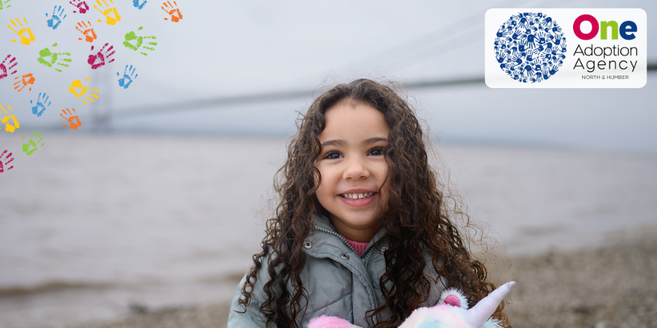 child holding unicorn on the foreshore in front of the Humber Bridge