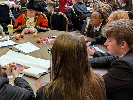 A photograph of the Mayor of Hull talking with young people of the Young People's Parliament